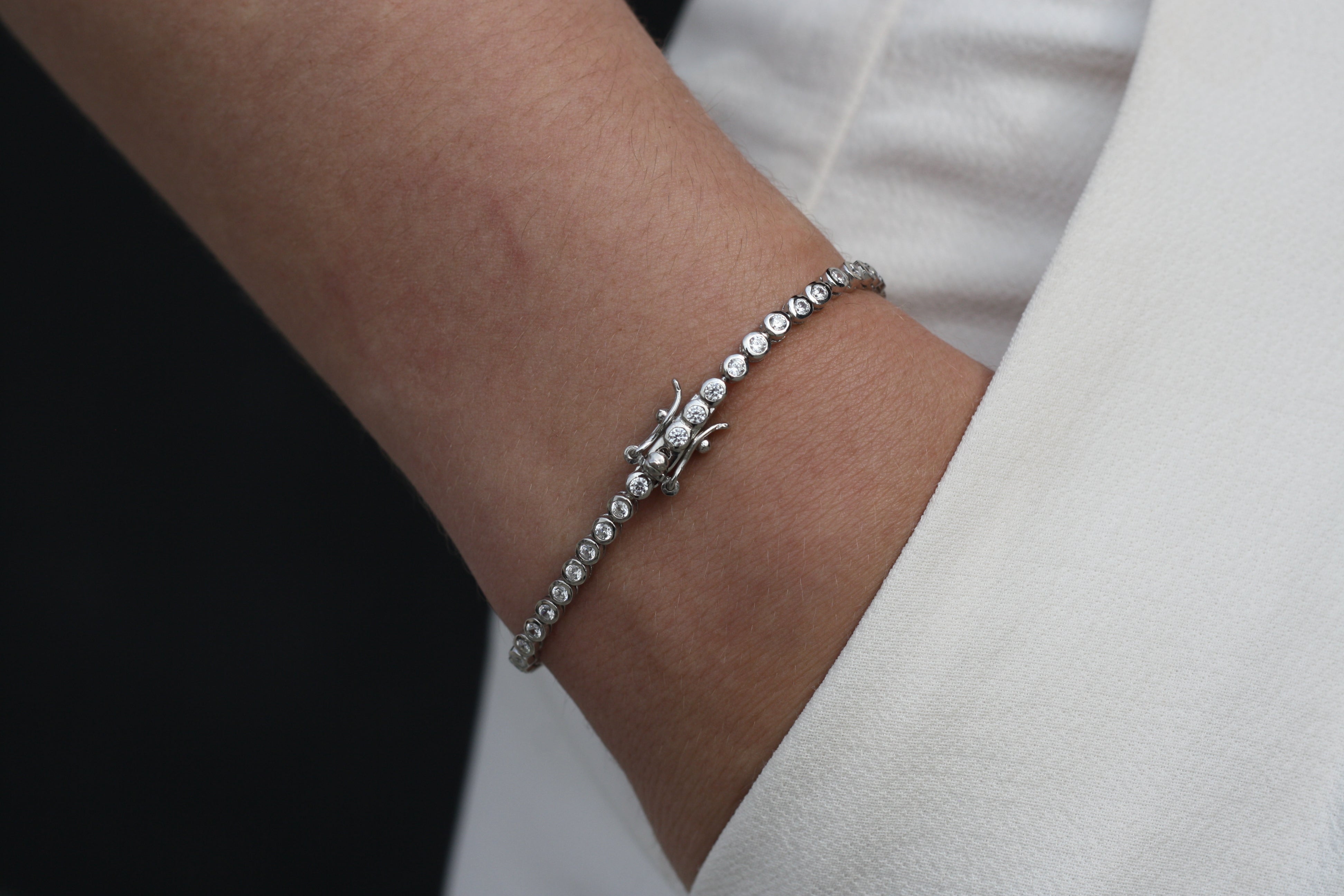 Sterling Silver Bracelet, Round Cut, Prong Clasp, Round Cut Bezel Bracelet in Silver, Pure Sterling Silver, AAA Grade Cubic Zirconia Stones, Silver, Dainty Tennis Bracelet, Men's Jewelry, Women's Jewelry, Men's Bracelet, Women's Bracelet, Unisex Bracelet, Aritzia White Effortless Pants, Black Wall, Fair Skin, Hand in Pocket